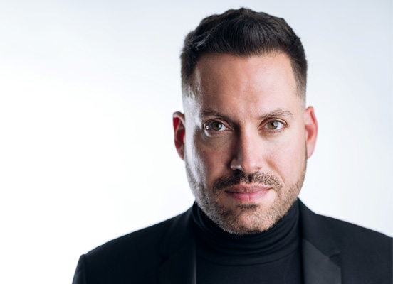 Head and shoulders photo of Artistic Director Jean-Sebastien Vallee. He is wearing a black turtle neck and jacket and is looking directly at the camera.