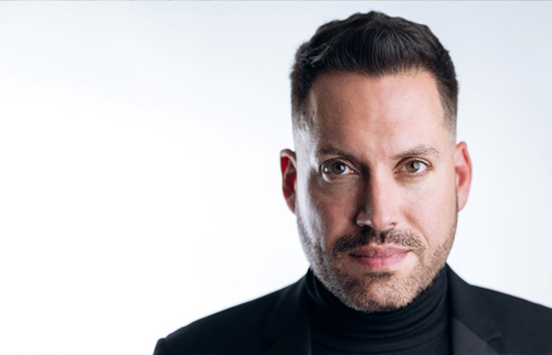 Head and shoulders photo of Artistic Director Jean-Sebastien Vallee. He is wearing a black turtle neck and jacket and is looking directly at the camera.