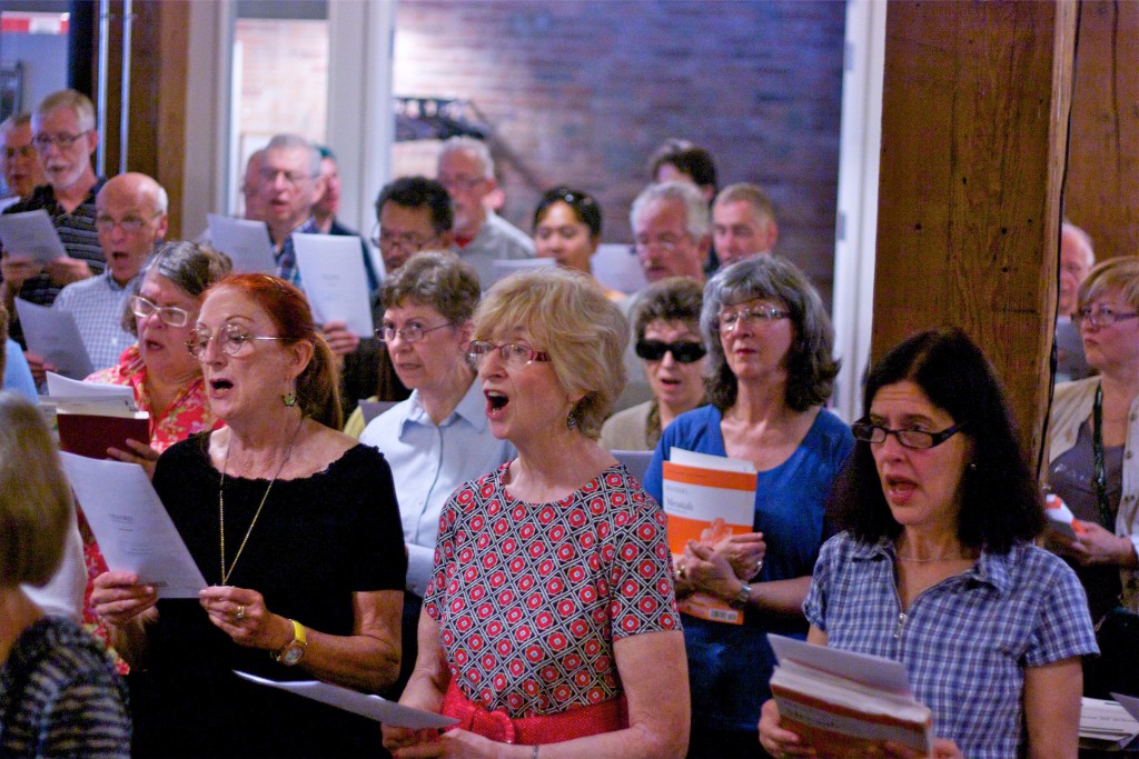 Singers at Singsation Saturday, reading from Messiah scores.