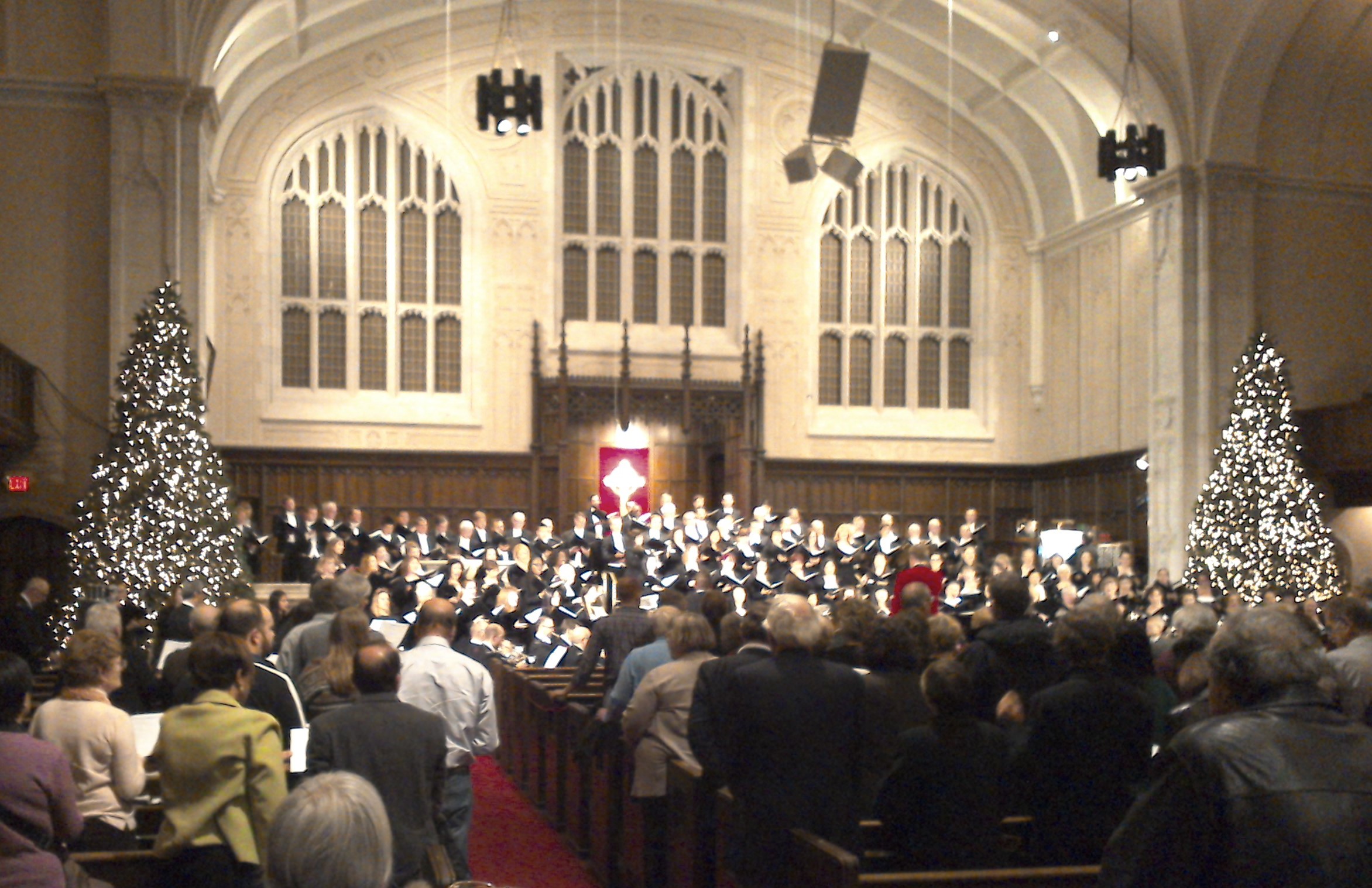An audience-eye view of the sanctuary of Yorkminster Park Baptist Church, with the choir at the front of the church and rows of audience members in the foreground.